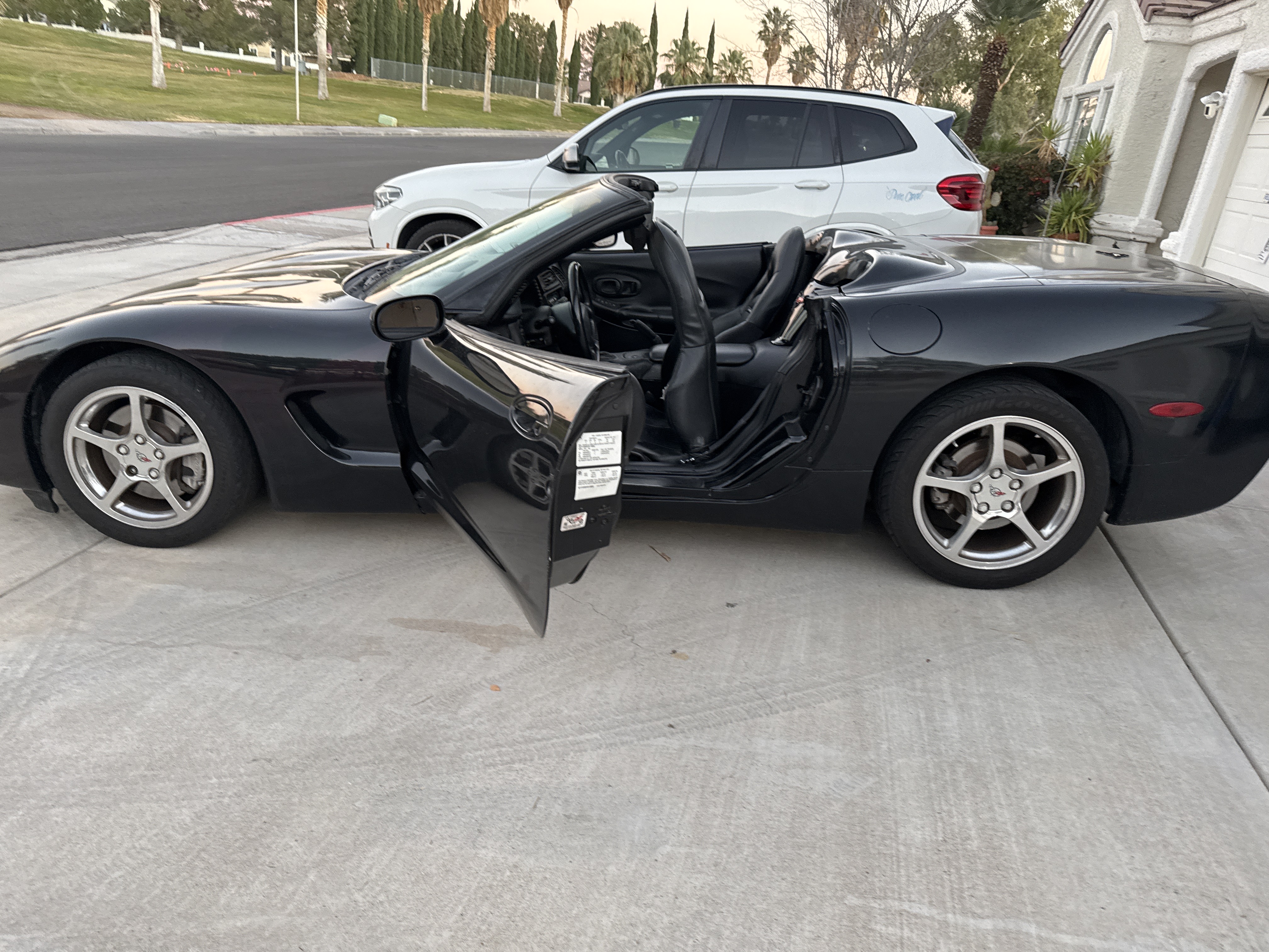 Black Corvette convertible with doors open